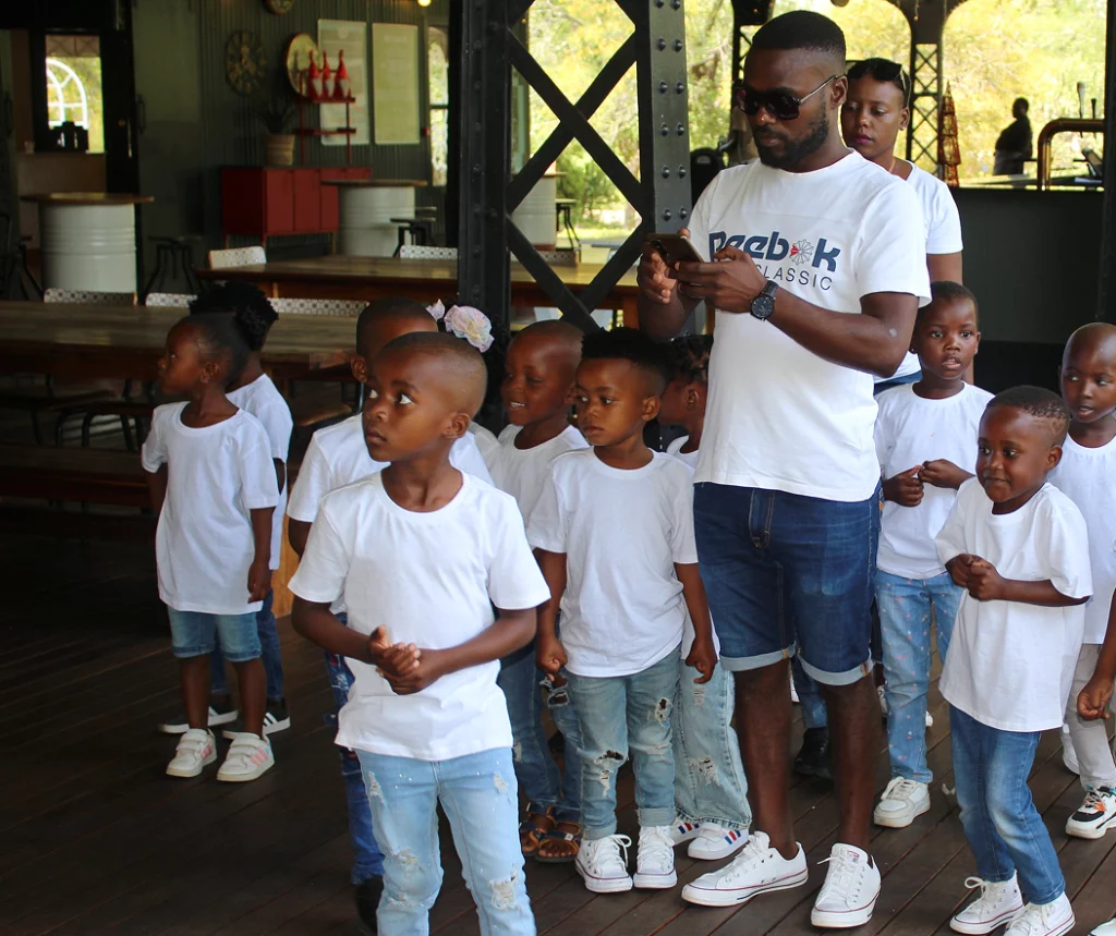 A group of kids and a parent all together in a safari lodge