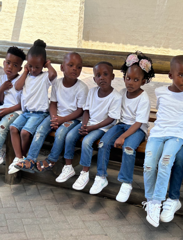 A group of children learners sitting together at a safari lodge