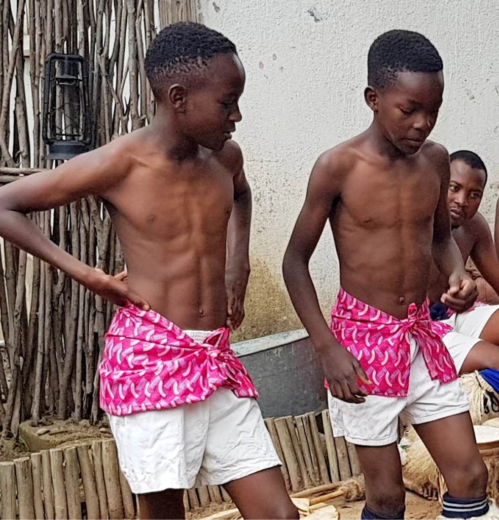 2 young boys getting ready to go down a water slide
